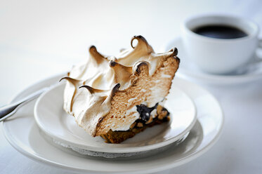 Slice of meringue pie with chocolate on restaurant table - ISF12759