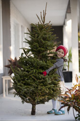 Girl carrying a christmas tree - ISF12909