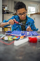 Boy working on science project at home - ISF12942