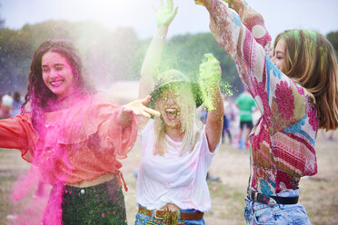 Portrait of friends at music festival, colour powder - ABIF00615