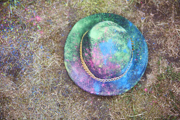 Hat with colour powder on the grass - ABIF00619