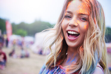 Portrait of happy young woman having fun with colorful powder - ABIF00626