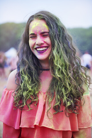 Portrait of young woman with colour powder at music festival stock photo