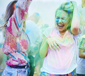 Friends dancing at music festival, holi powder - ABIF00633