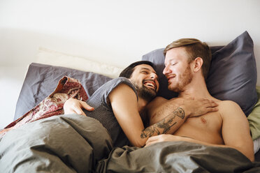 Male couple in bed, embracing, face to face - ISF13039
