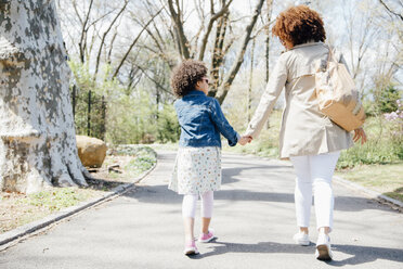 Full length rear view of mother and daughter walking holding hands - ISF13053