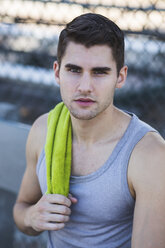 Portrait of young male basketball player with towel on shoulder - ISF13296