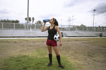 Soccer player drinking in field - ISF13309