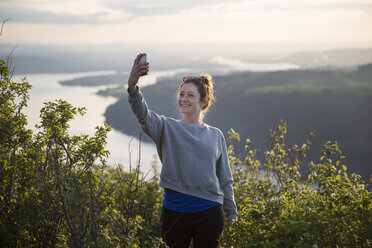 Frau macht Selfie auf einem Hügel, Angel's Rest, Columbia River Gorge, Oregon, USA - ISF13344