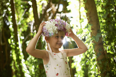 Portrait of pretty girl wearing flower headdress in forest - ISF13798