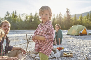 Portrait of boy with parents on camping trip, looking at camera - ISF13840