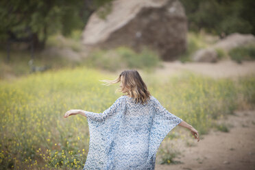 Woman dancing in park, Stoney Point, Topanga Canyon, Chatsworth, Los Angeles, California, USA - ISF13994