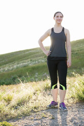 Portrait of young female runner on hillside - ISF14066