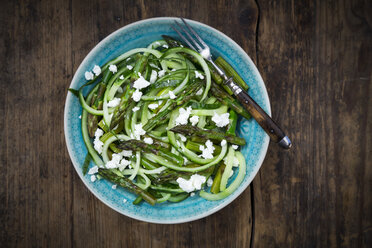 Bowl of green asparagus salad with helically coiled cucumber and feta cheese - LVF07120