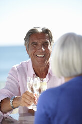 Couple enjoying wine by seaside - CUF33209