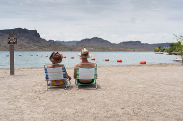 Couple sitting on deck chairs, Lake Havasu, Arizona, USA - CUF33268