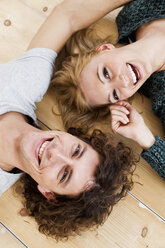 Studio shot couple lying on floor - CUF33279