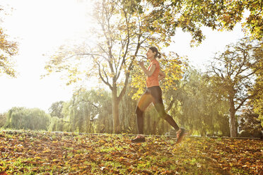 Woman jogging in woods - CUF33294