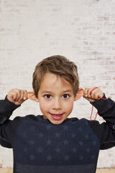 Studio-Porträt eines Jungen, der an seinen Ohren zieht - CUF33337