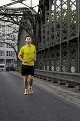 Young man running on bridge - CUF33368