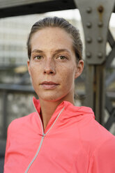 Portrait of confident young female runner on bridge - CUF33376