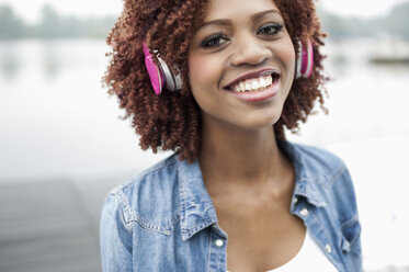 Portrait of young woman wearing headphones - CUF33409
