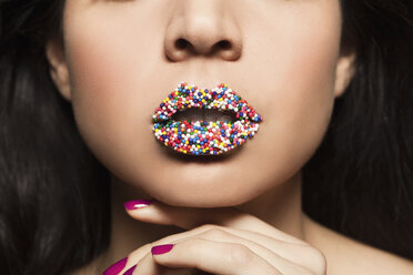 Mid adult woman with sprinkles on lips - ISF14132