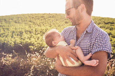 Mid adult man holding baby daughter - CUF33491