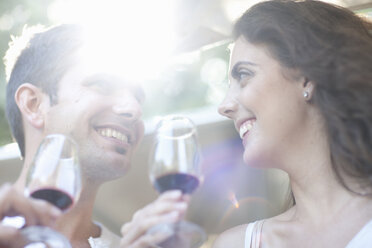 Young couple enjoying wine tasting at vineyard - CUF33604