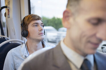 Junger Mann mit Kopfhörern im Zug - CUF33615