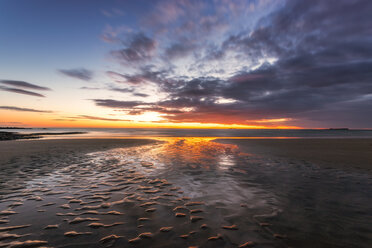 United Kingdom, England, Northumberland, Bamburgh beach with Farne Islands in distance at sunrise - SMAF01035