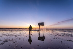 Vereinigtes Königreich, England, Northumberland, Pfosten zur Markierung des Pilgerwegs nach Lindisfarne mit Notunterkunft, Sonnenaufgang - SMAF01044