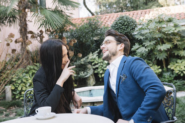 Happy elegant couple talking in a garden cafe - ALBF00540