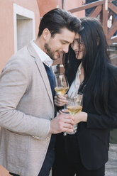 Elegant affectionate couple drinking wine in the city - ALBF00559