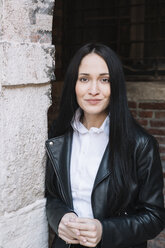 Portrait of smiling young woman wearing leather jacket - ALBF00565