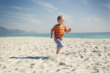 Boy running on beach, Cape Town, Western Cape, South Africa - CUF33709