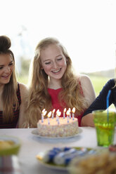 Teenage girl with birthday cake and candles - CUF33781