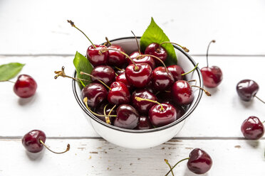 Bowl of cherries on white wood - SARF03799