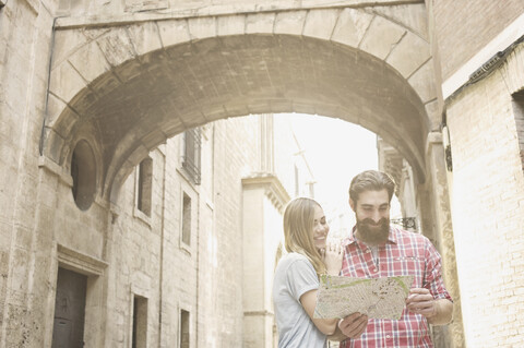 Young couple looking at map outside Valencia Cathedral, Valencia, Spain stock photo