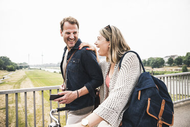 Happy couple crossing a bridge - UUF14301