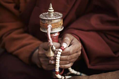 Close up of buddhist monks hands holding prayer beads, Thamel, Kathmandu, Nepal - CUF34095