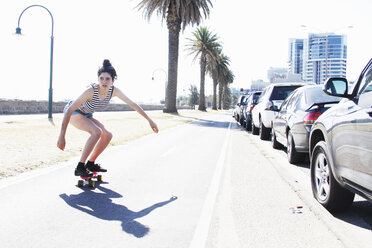 Young woman skateboarding, Port Melbourne, Melbourne, Australia - CUF34210