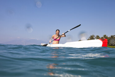 Kayaker rowing in sea - ISF14399