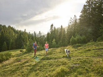 Austria, Tyrol, Mieming, couple with dog hiking in alpine scenery - CVF00867