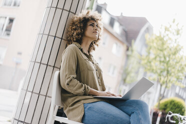 Woman working in a cafe, drinking coffee, using laptop - KNSF04140