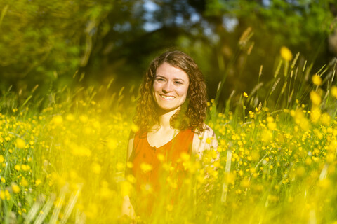 Young woman in summer meadow stock photo