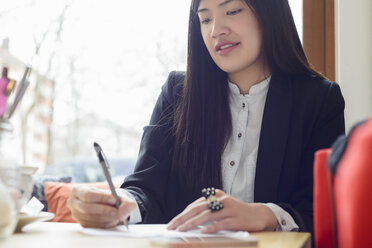 Business woman writing - CUF34698