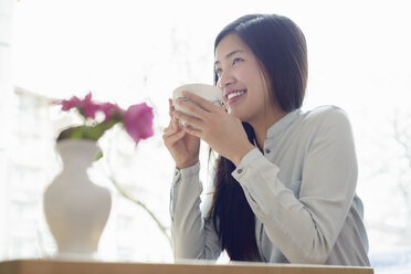 Woman relaxing with cup of tea - CUF34704