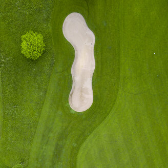 Germany, Baden-Wuerttemberg, Aerial view of golf course with bunker, green and hole - MMAF00397