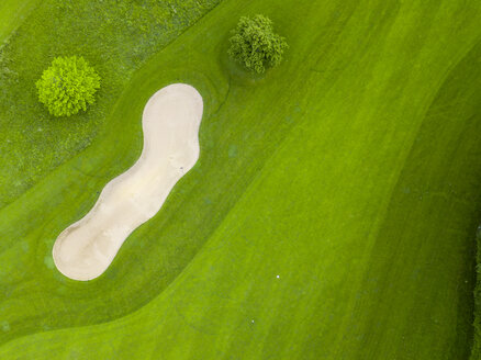 Germany, Baden-Wuerttemberg, Aerial view of golf course with bunker, green and hole - MMAF00399